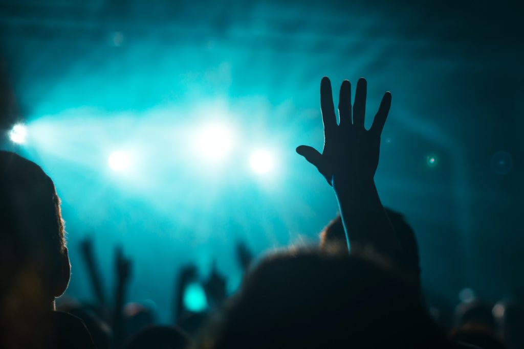 Female hand raised in the air on rock music concert